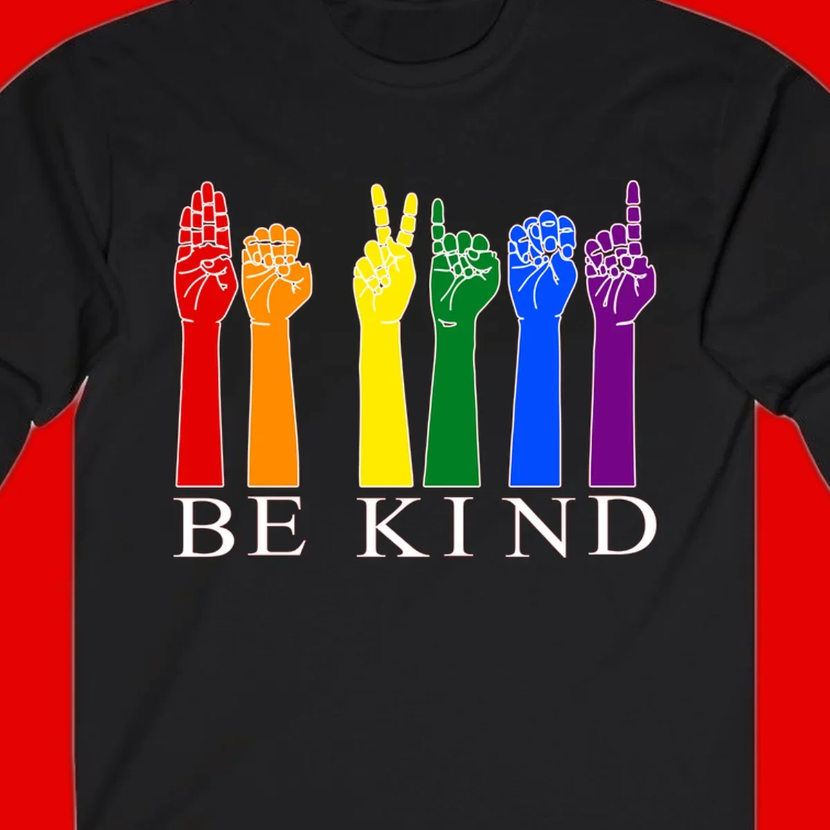 Six rainbow-colored raised hands in red, orange, yellow, green, blue, and purple with white line details and 'BE KIND' text below