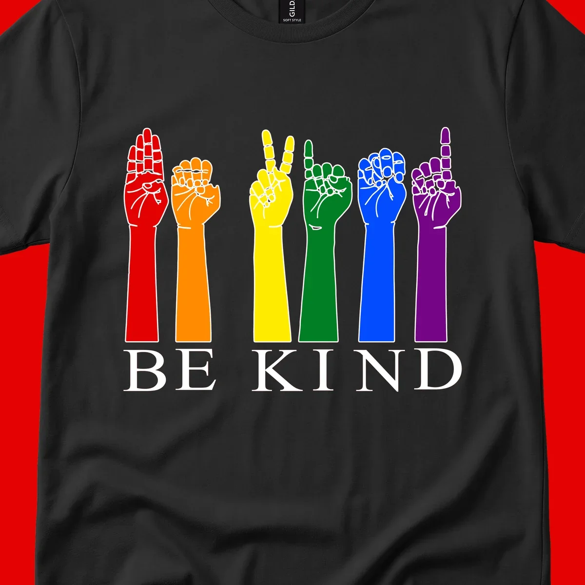 Six rainbow-colored raised hands in red, orange, yellow, green, blue, and purple with white line details and 'BE KIND' text below