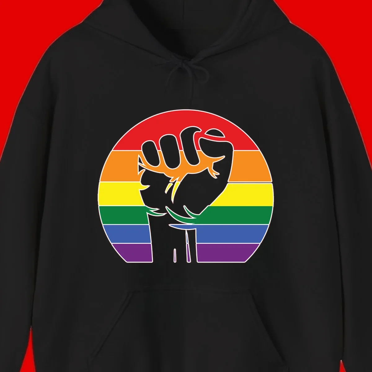 Gray dachshund with elongated body stretching across circular rainbow pride flag stripes in red, orange, yellow, green, blue, and purple