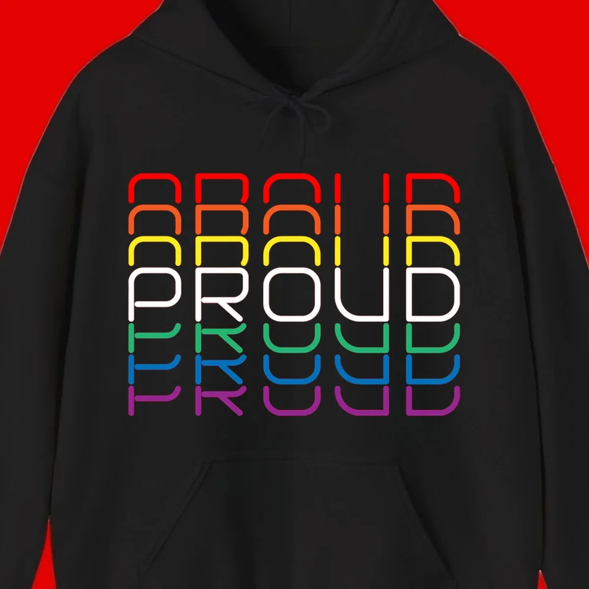 The word PROUD displayed in large rounded letters, each stacked layer colored in rainbow pride spectrum colors from red to purple
