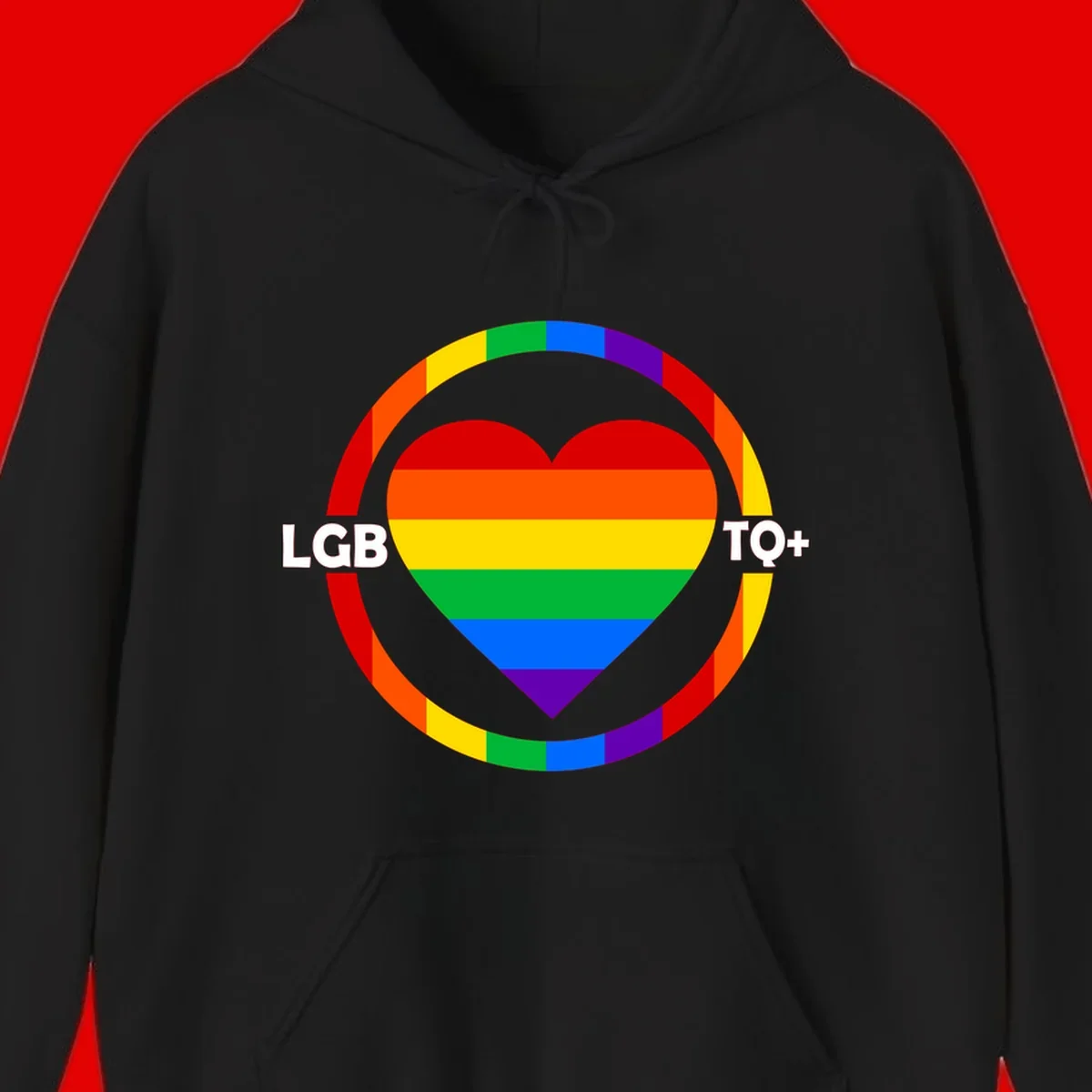 Rainbow heart with LGB TO+ text in concentric pride circles on gray background