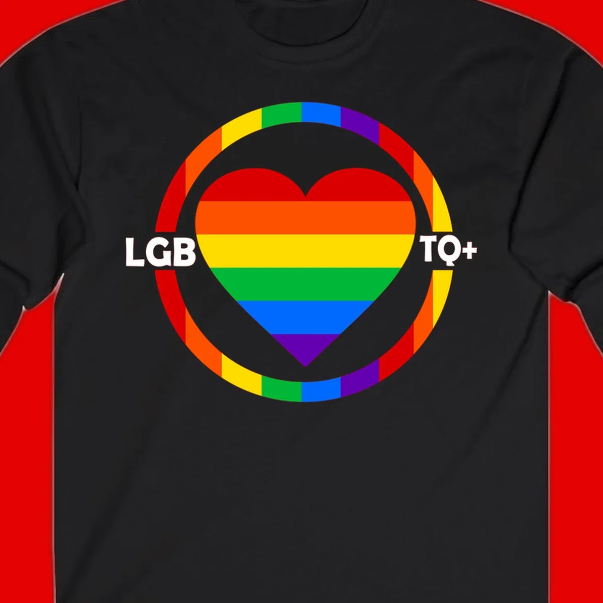 Rainbow heart with LGB TO+ text in concentric pride circles on gray background