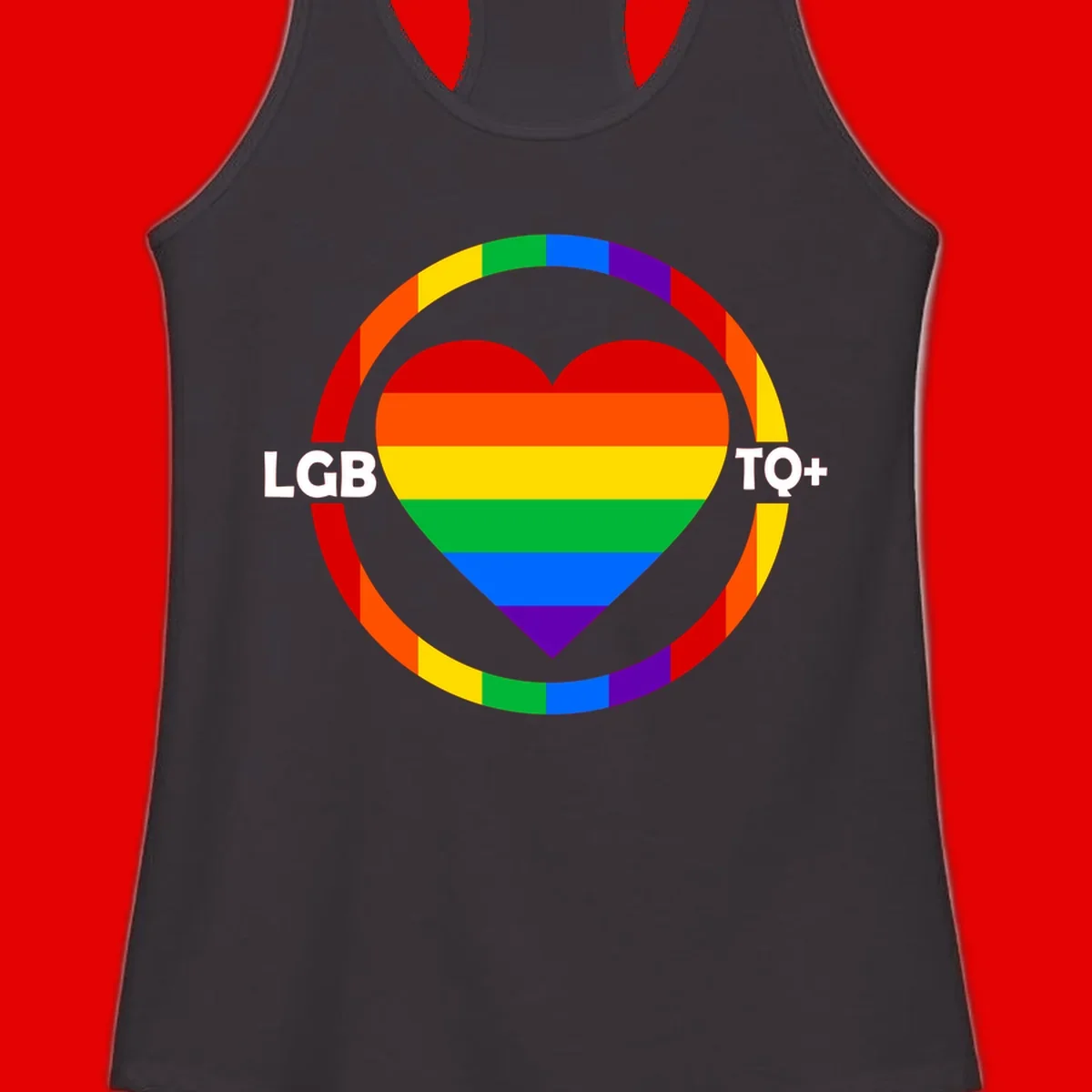 Rainbow heart with LGB TO+ text in concentric pride circles on gray background