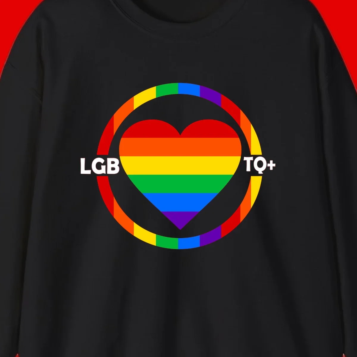 Rainbow heart with LGB TO+ text in concentric pride circles on gray background