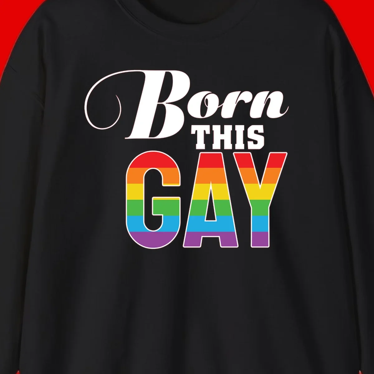 Born This Gay pride design with rainbow flag stripes filling large letters on gray background