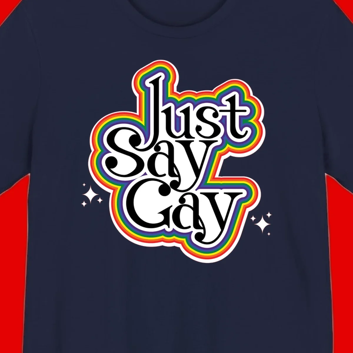 Just Say Gay Pride design with bold black text surrounded by vibrant rainbow border and sparkle accents on gray background