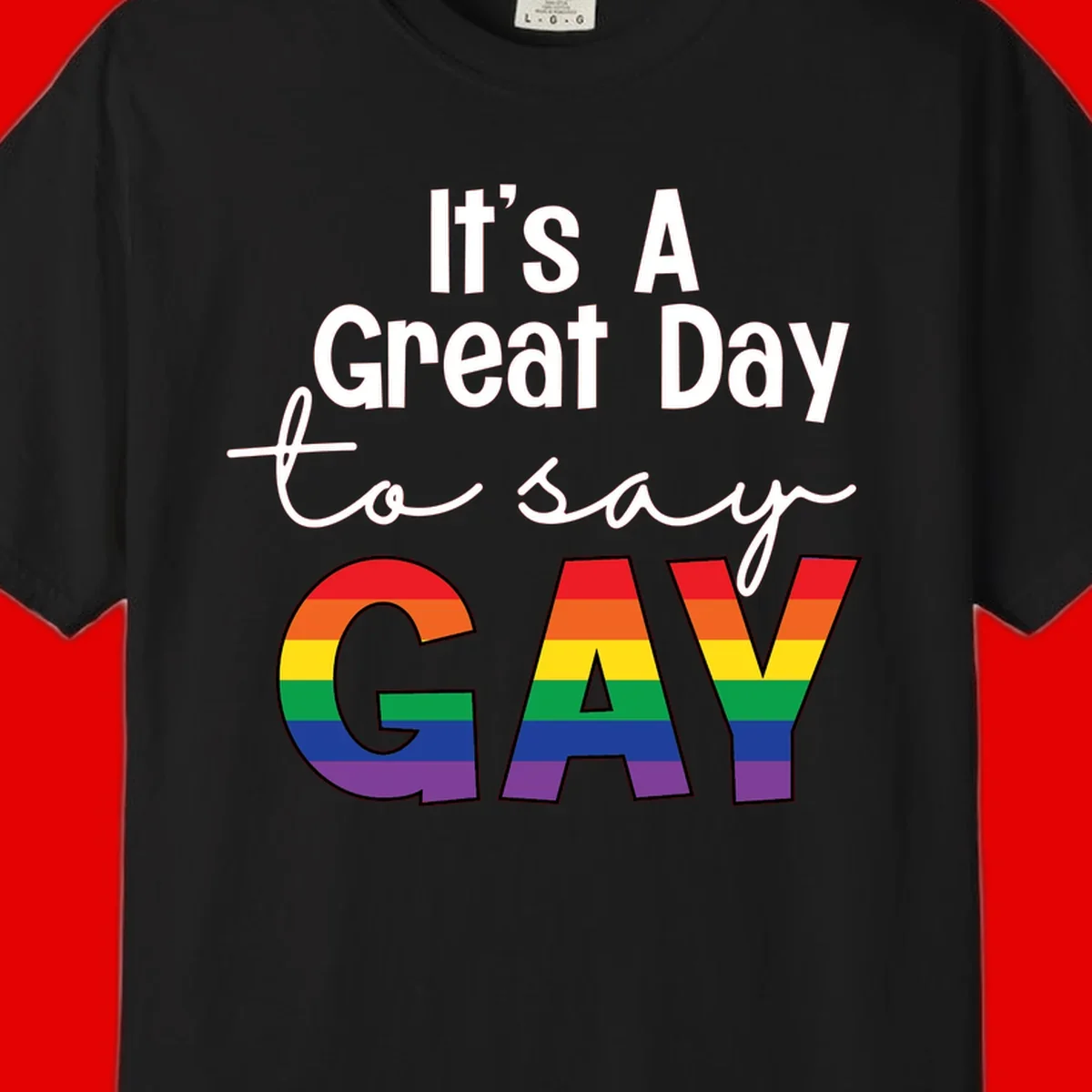 Gray background with white text reading 'It's A Great Day To Say' and the word 'GAY' in large letters filled with rainbow pride flag stripes