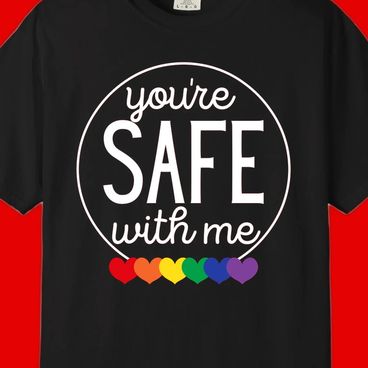 Circular badge with 'you're SAFE with me' text and rainbow pride hearts, promoting inclusive safe space message