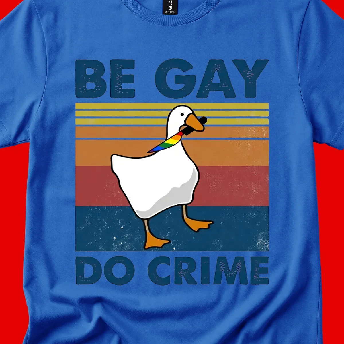 White duck with rainbow wing on retro striped background with 'Be Gay Do Crime' text, pride design