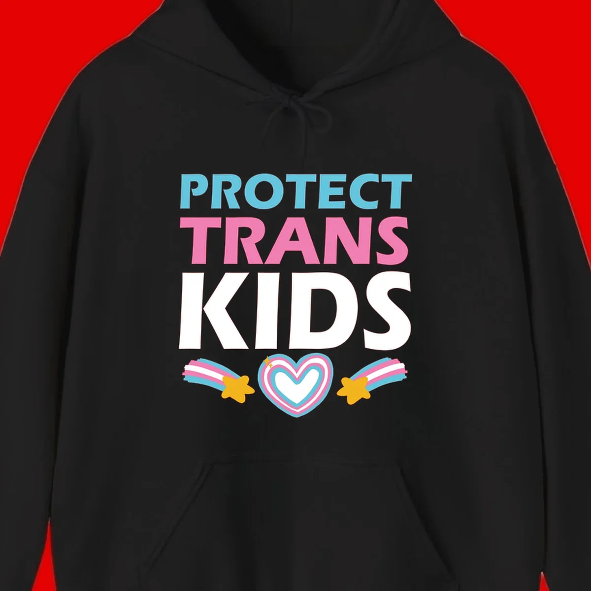 Protect trans kids pride design with cyan, pink and white text, concentric heart, and gold shooting stars with rainbow trails