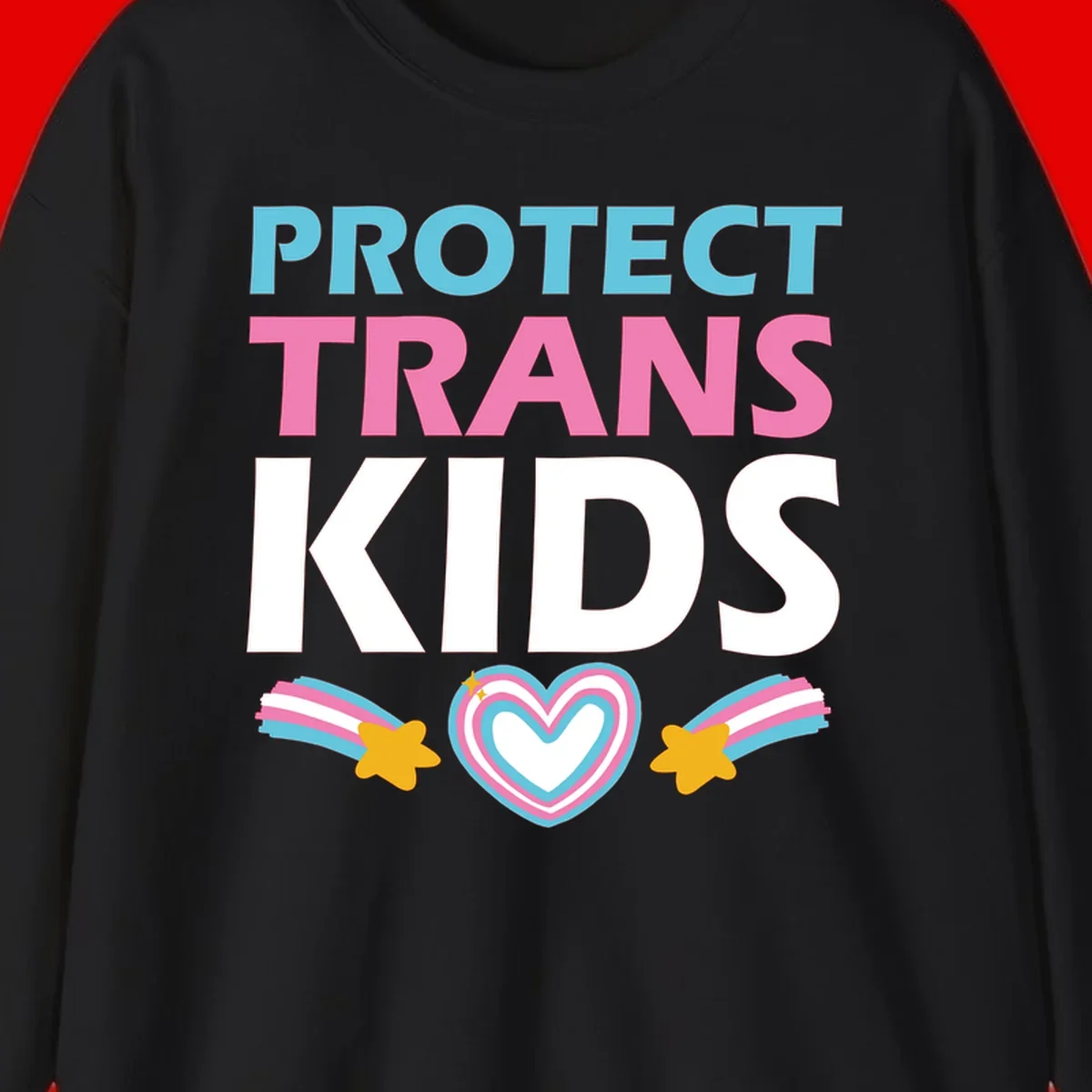 Protect trans kids pride design with cyan, pink and white text, concentric heart, and gold shooting stars with rainbow trails