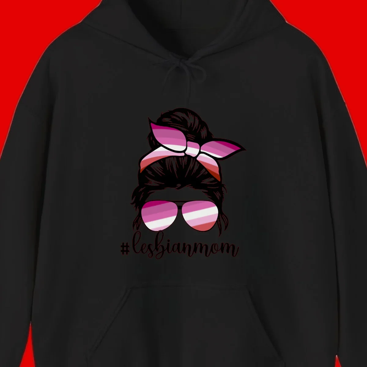 Illustration of a woman with black hair, pink bow, and aviator sunglasses featuring lesbian pride flag stripes with #lesbianmom text