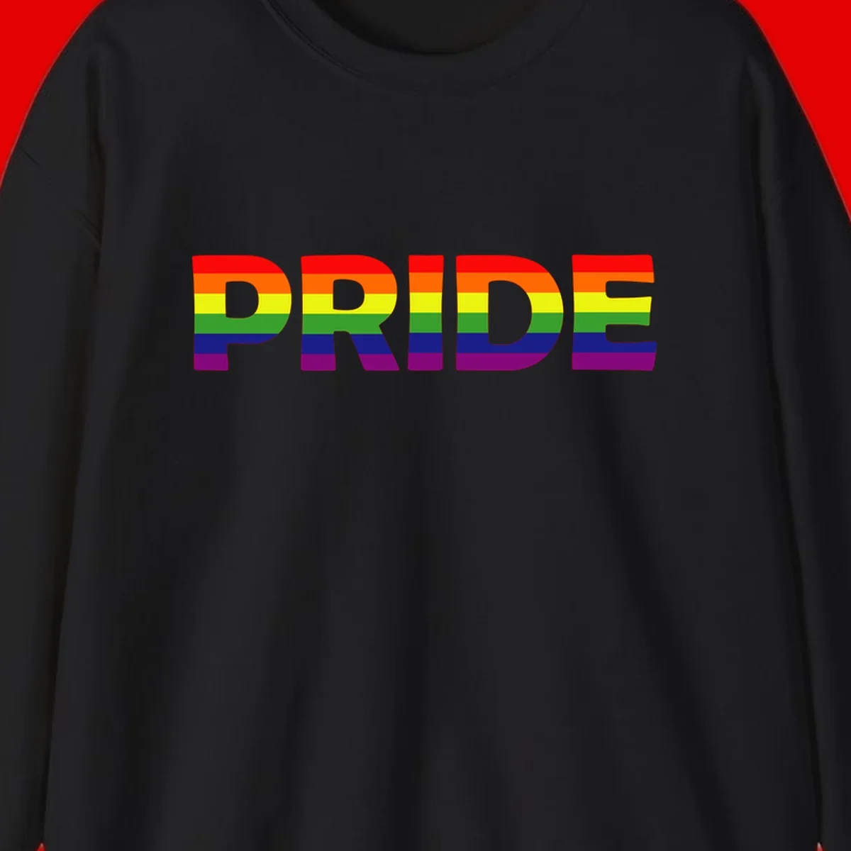 The word PRIDE in large letters filled with rainbow pride flag stripes on gray background