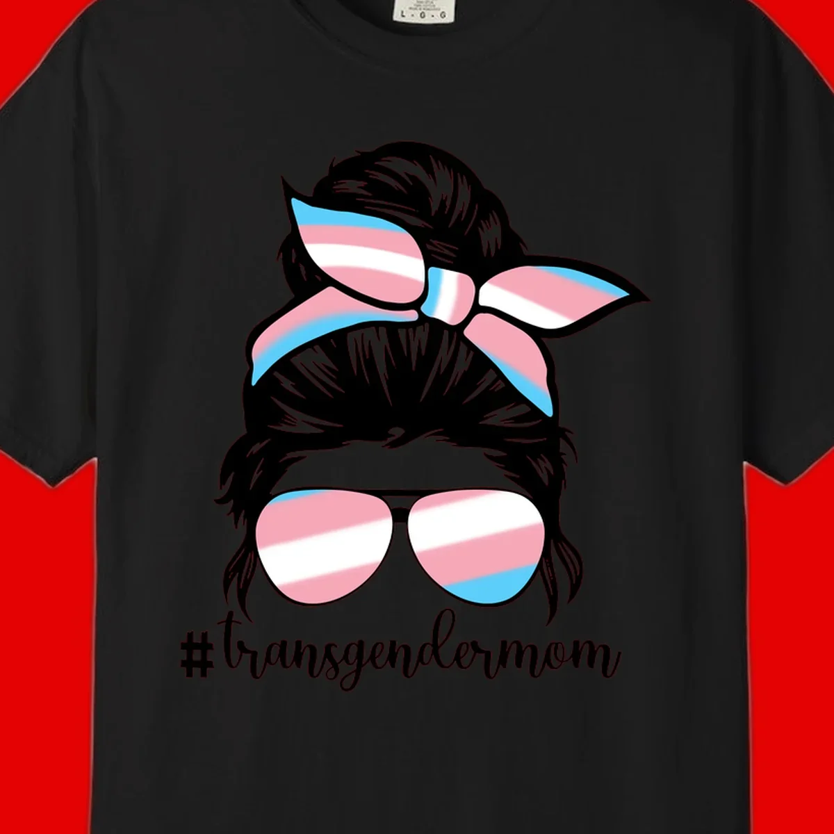 Stylized portrait with black hair, cat-eye sunglasses and bow in transgender flag colors, #transgendermom text below