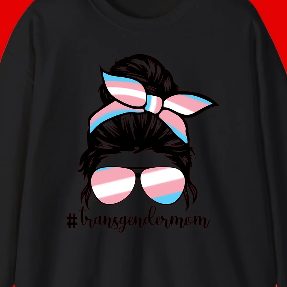 Stylized portrait with black hair, cat-eye sunglasses and bow in transgender flag colors, #transgendermom text below