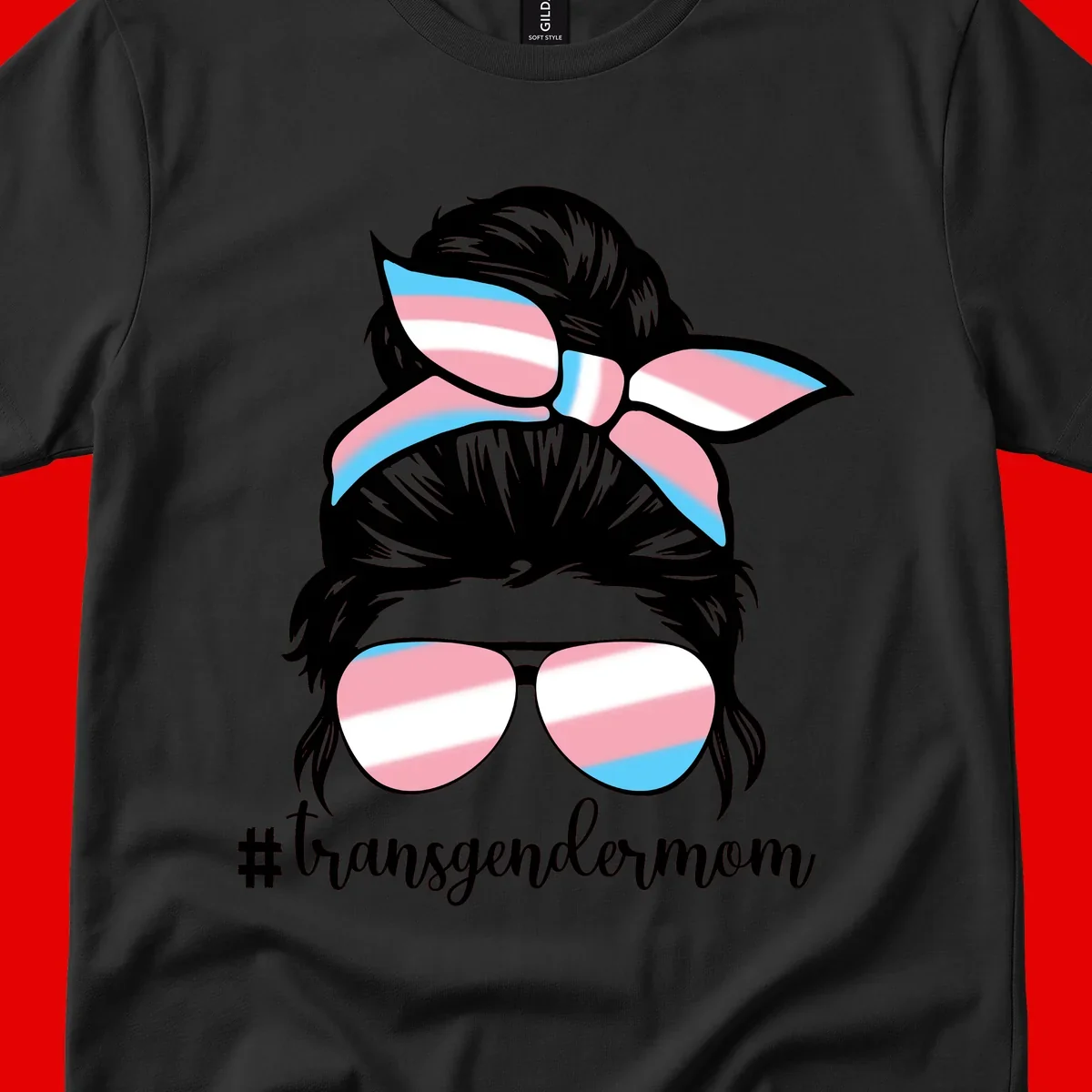 Stylized portrait with black hair, cat-eye sunglasses and bow in transgender flag colors, #transgendermom text below