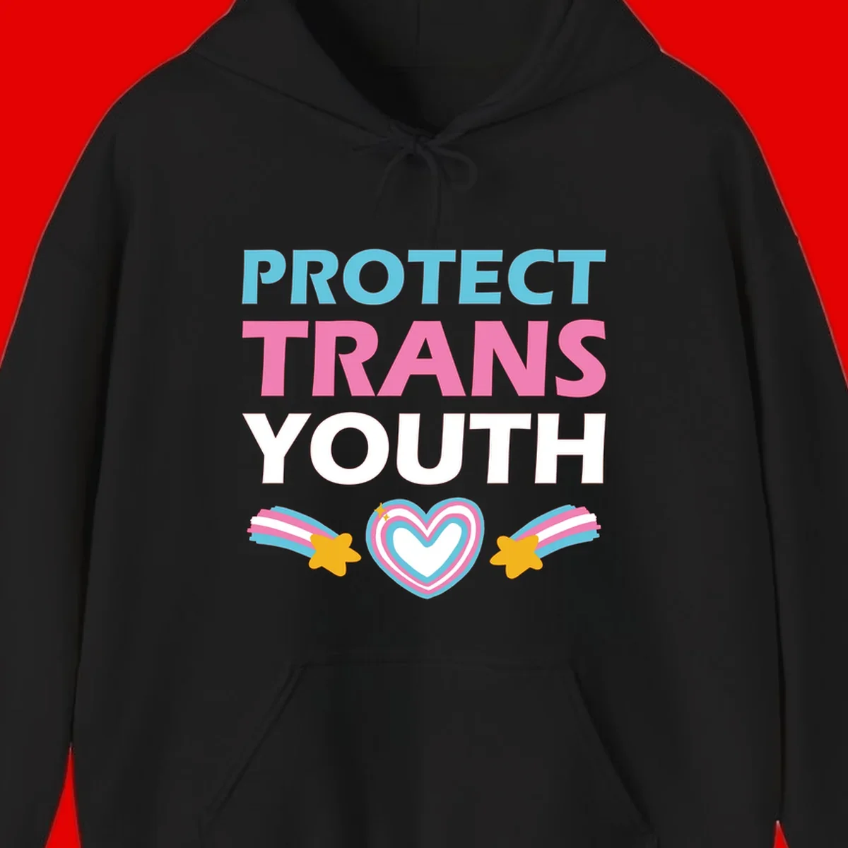 Protect trans youth design with cyan, pink, and white text, rainbow heart, and gold stars on gray background