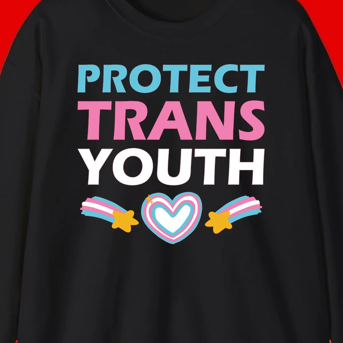 Protect trans youth design with cyan, pink, and white text, rainbow heart, and gold stars on gray background