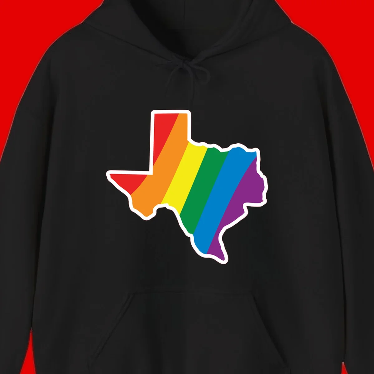 Texas state map filled with diagonal rainbow pride flag stripes in red, orange, yellow, green, blue, and purple with white border