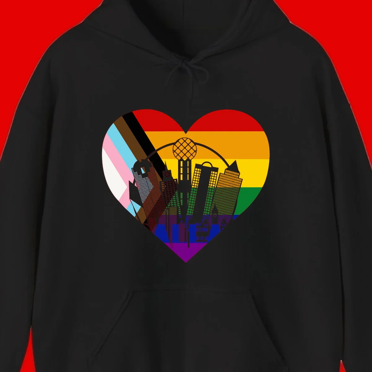 Heart-shaped design with rainbow pride flag and gray city skyline featuring skyscrapers and urban architecture