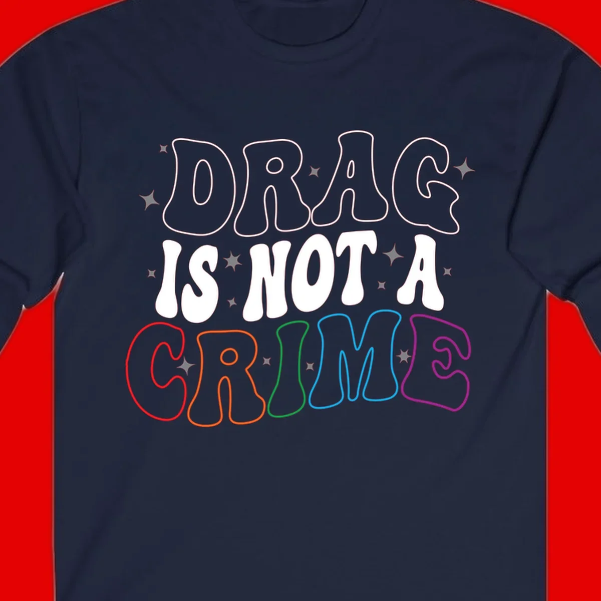 Drag is not a crime design with white and rainbow-colored outlined text on gray background