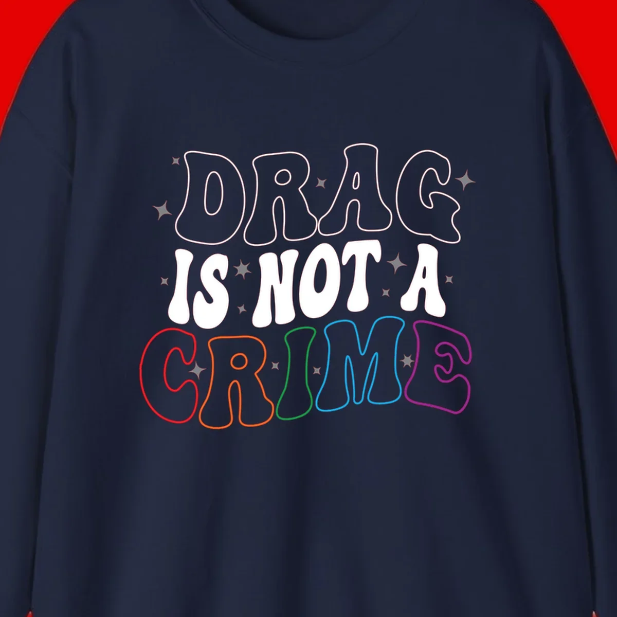 Drag is not a crime design with white and rainbow-colored outlined text on gray background