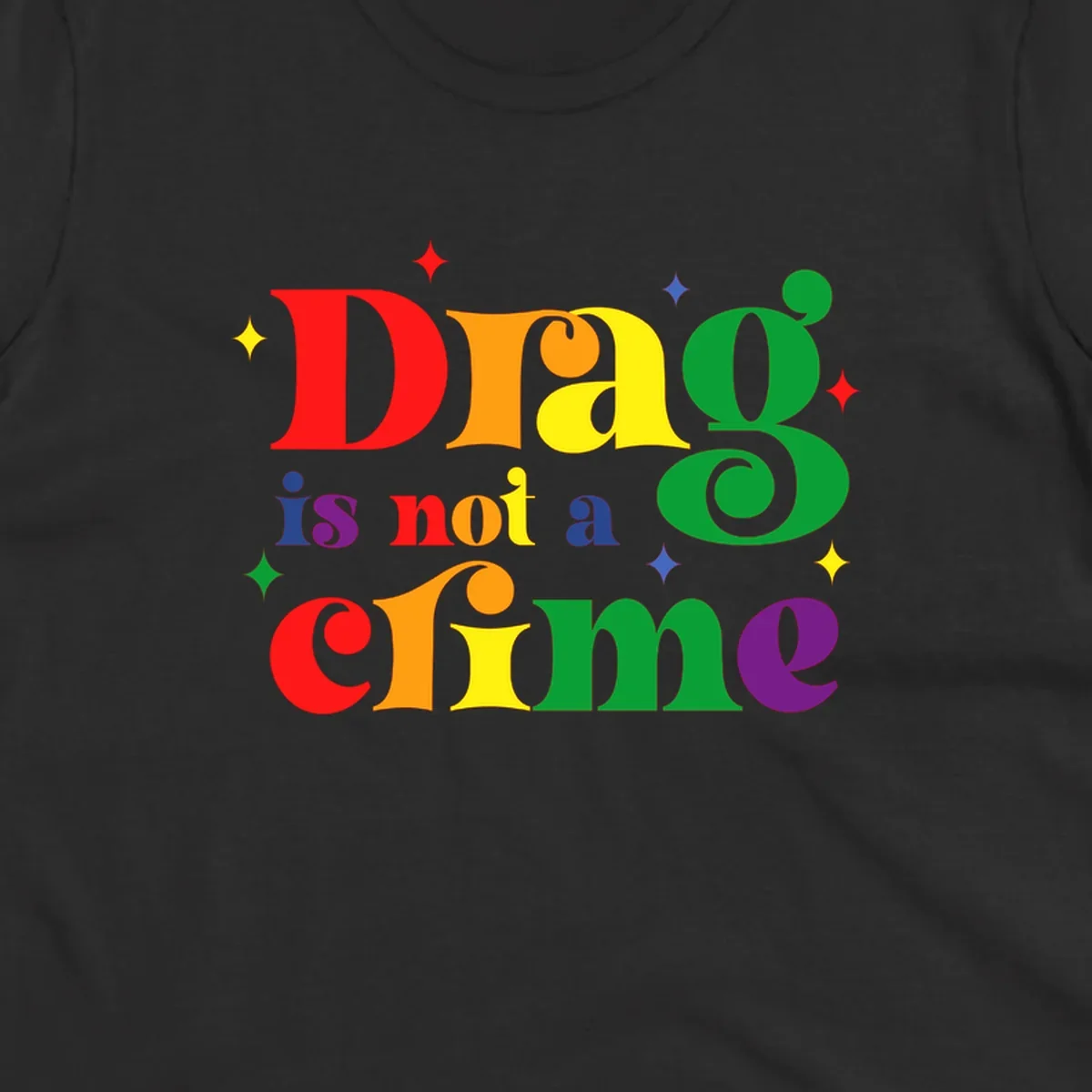 Colorful rainbow typography spelling 'Drag is not a crime' with decorative stars on gray background