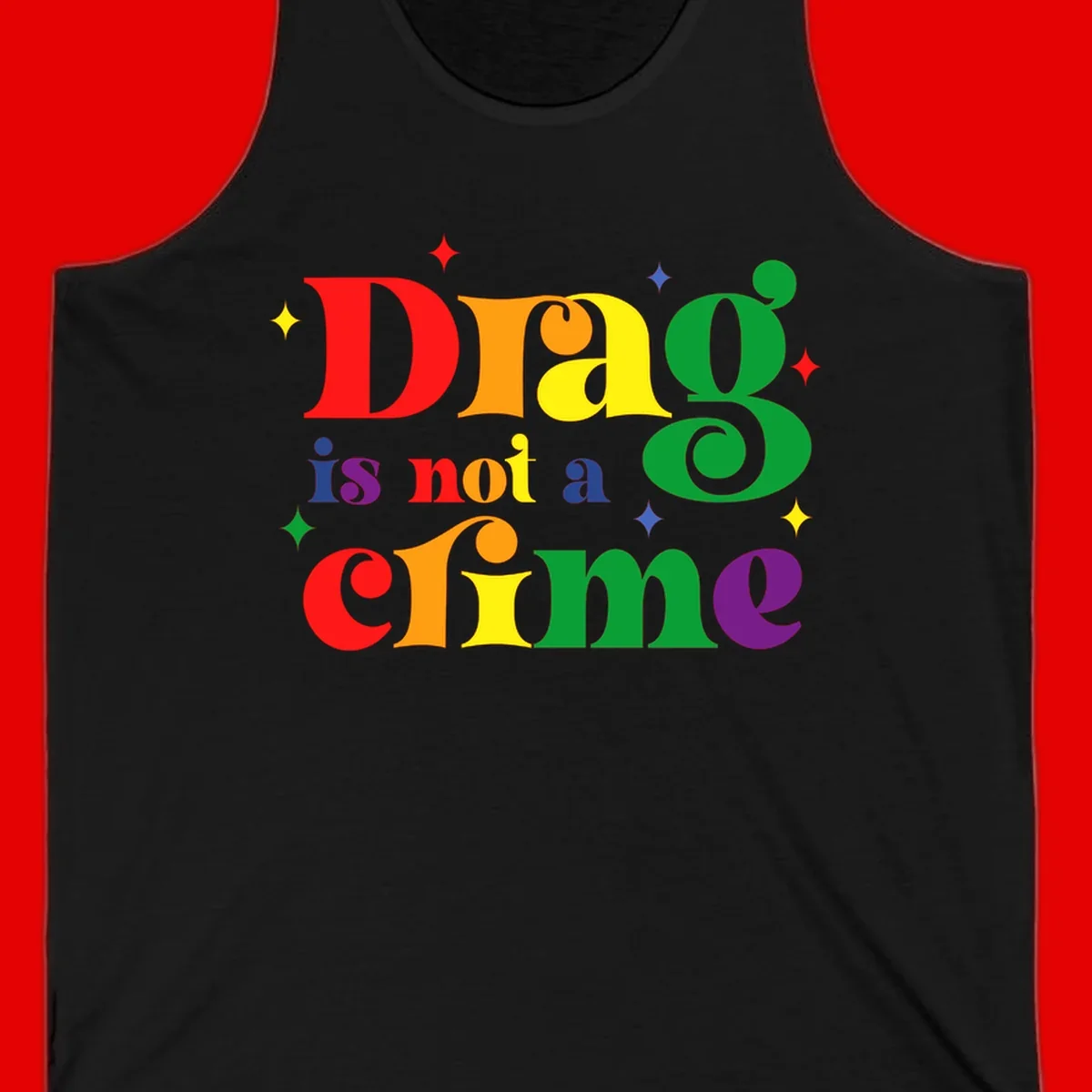 Colorful rainbow typography spelling 'Drag is not a crime' with decorative stars on gray background