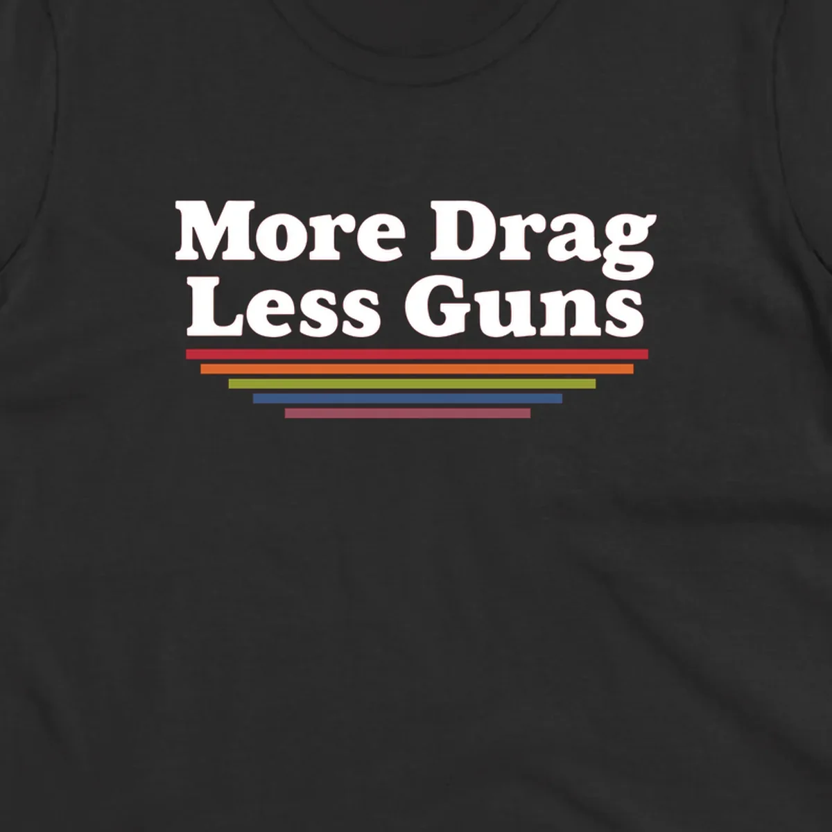More Drag Less Guns design: white text on gray background with colored horizontal bars representing pride and activism