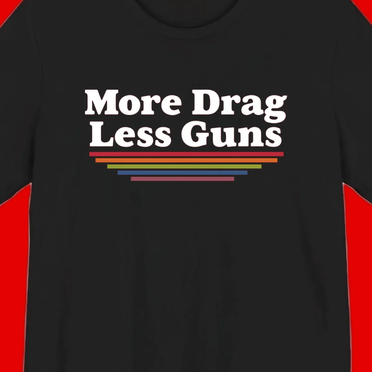 More Drag Less Guns design: white text on gray background with colored horizontal bars representing pride and activism