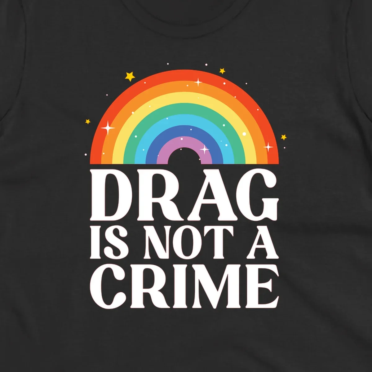 Colorful rainbow arc with stars above white text reading 'Drag Is Not A Crime' on gray background