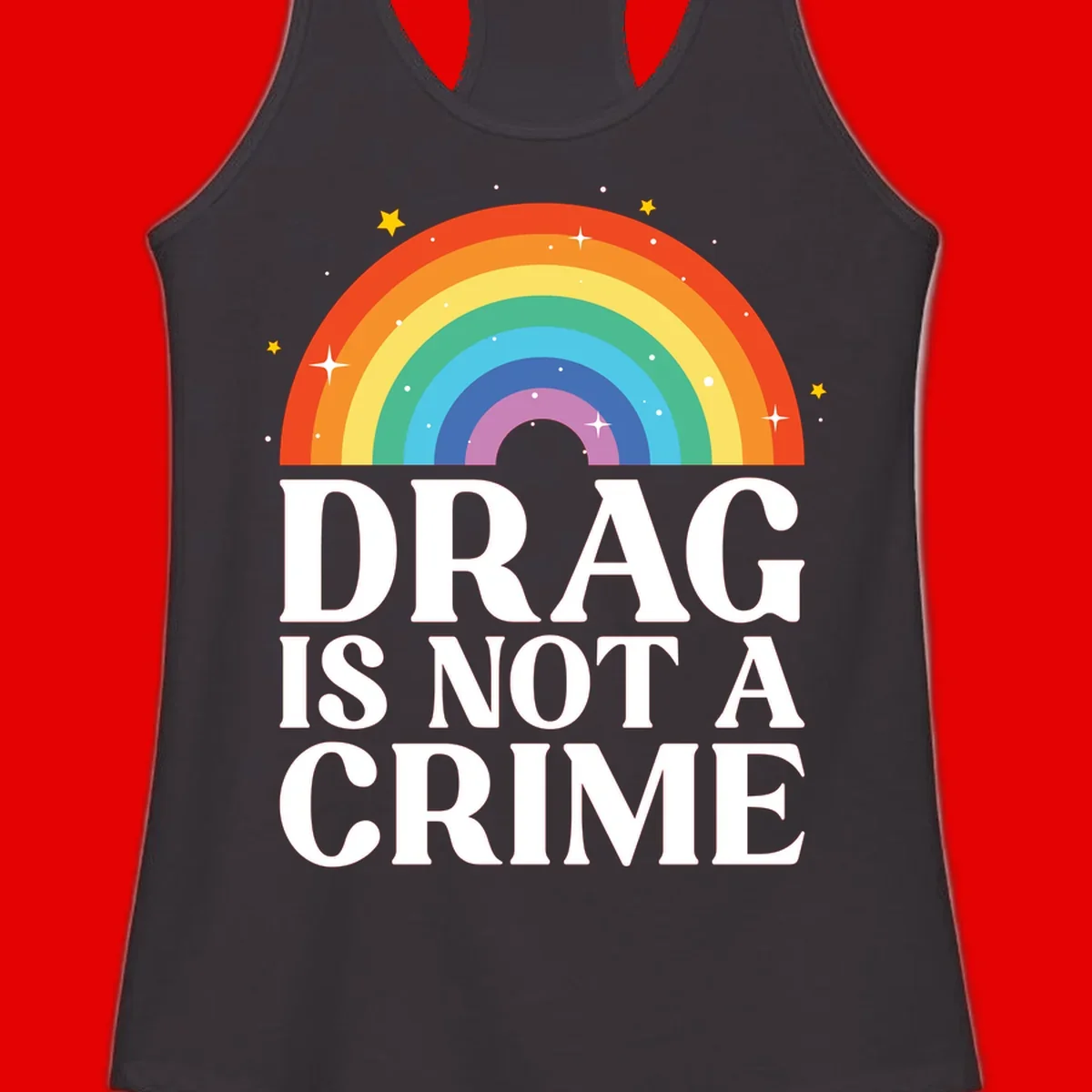 Colorful rainbow arc with stars above white text reading 'Drag Is Not A Crime' on gray background