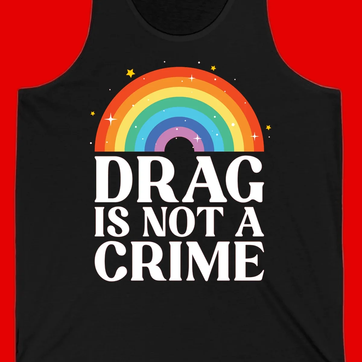Colorful rainbow arc with stars above white text reading 'Drag Is Not A Crime' on gray background