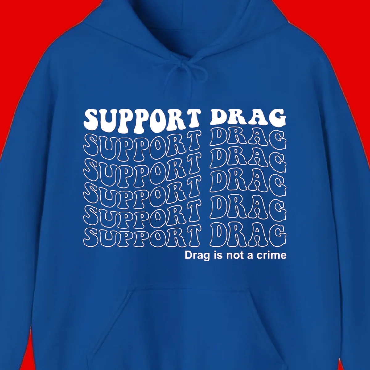 Gray t-shirt design with white text reading 'Support Drag' repeated throughout and 'Drag is not a crime' at bottom