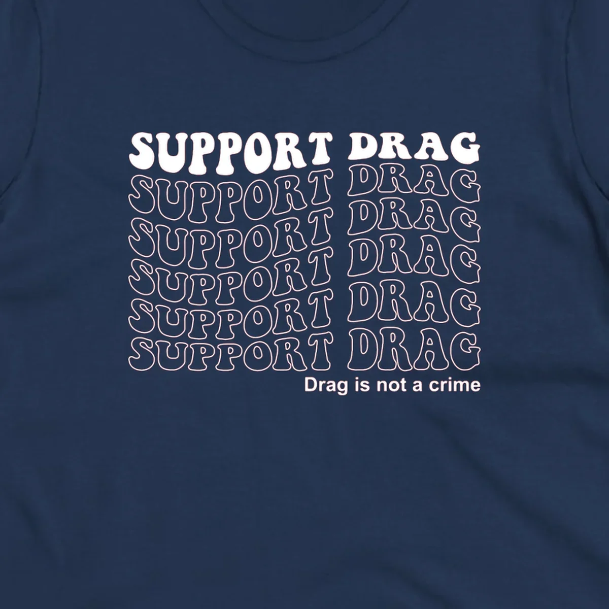 Gray t-shirt design with white text reading 'Support Drag' repeated throughout and 'Drag is not a crime' at bottom