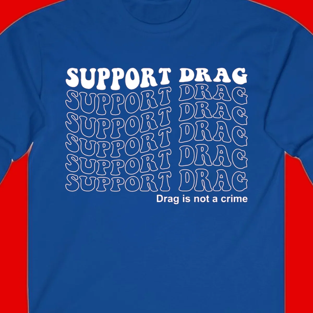 Gray t-shirt design with white text reading 'Support Drag' repeated throughout and 'Drag is not a crime' at bottom