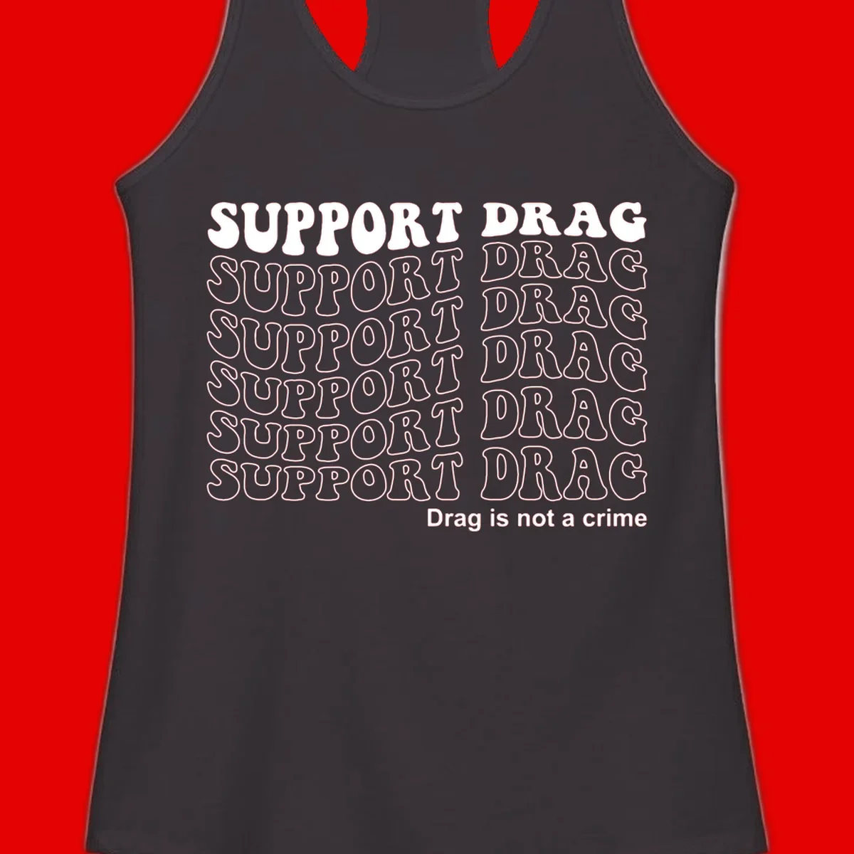 Gray t-shirt design with white text reading 'Support Drag' repeated throughout and 'Drag is not a crime' at bottom