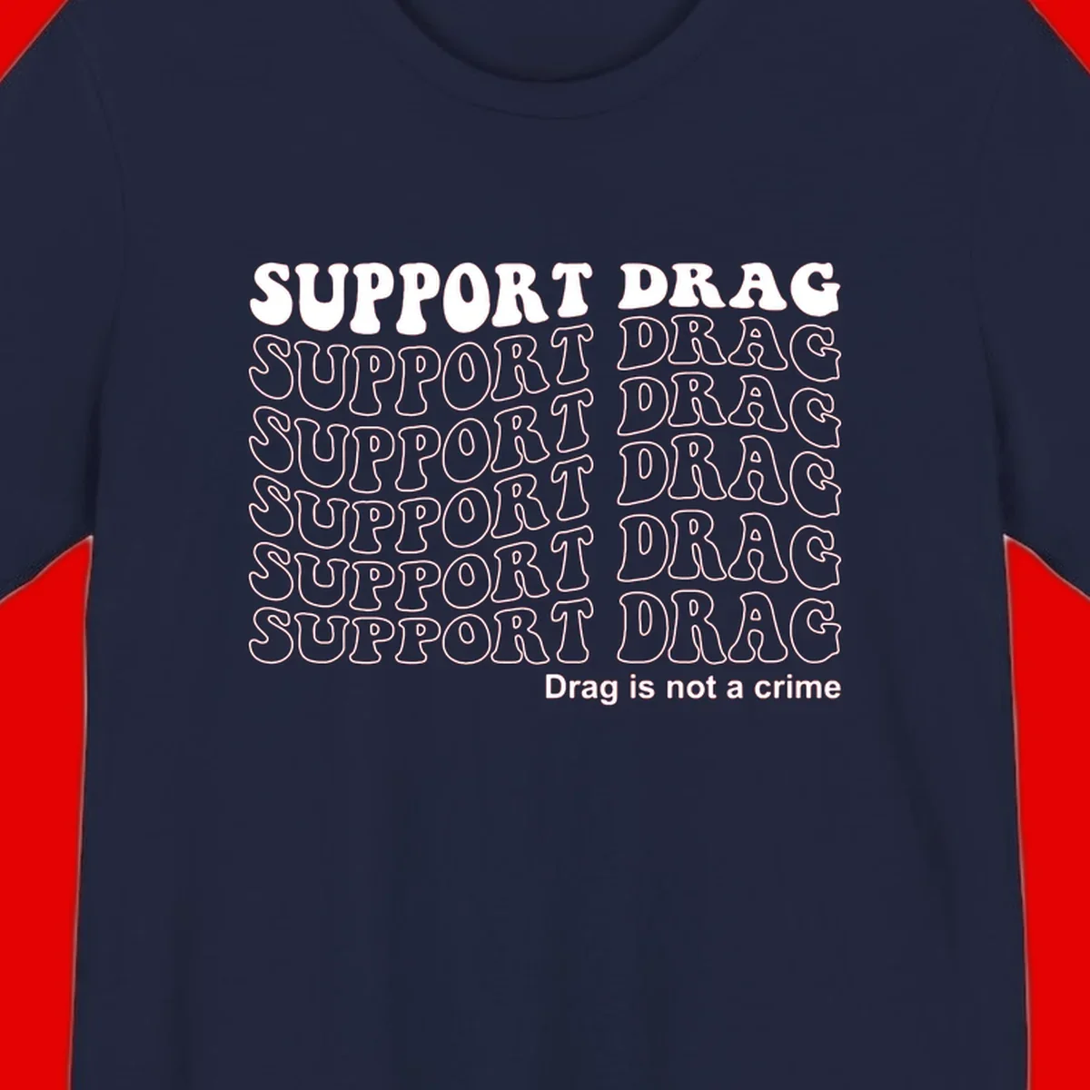 Gray t-shirt design with white text reading 'Support Drag' repeated throughout and 'Drag is not a crime' at bottom