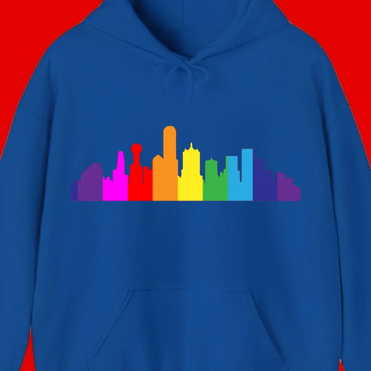 Colorful city skyline silhouette in rainbow pride colors transitioning from purple through red, orange, yellow, green, cyan and blue
