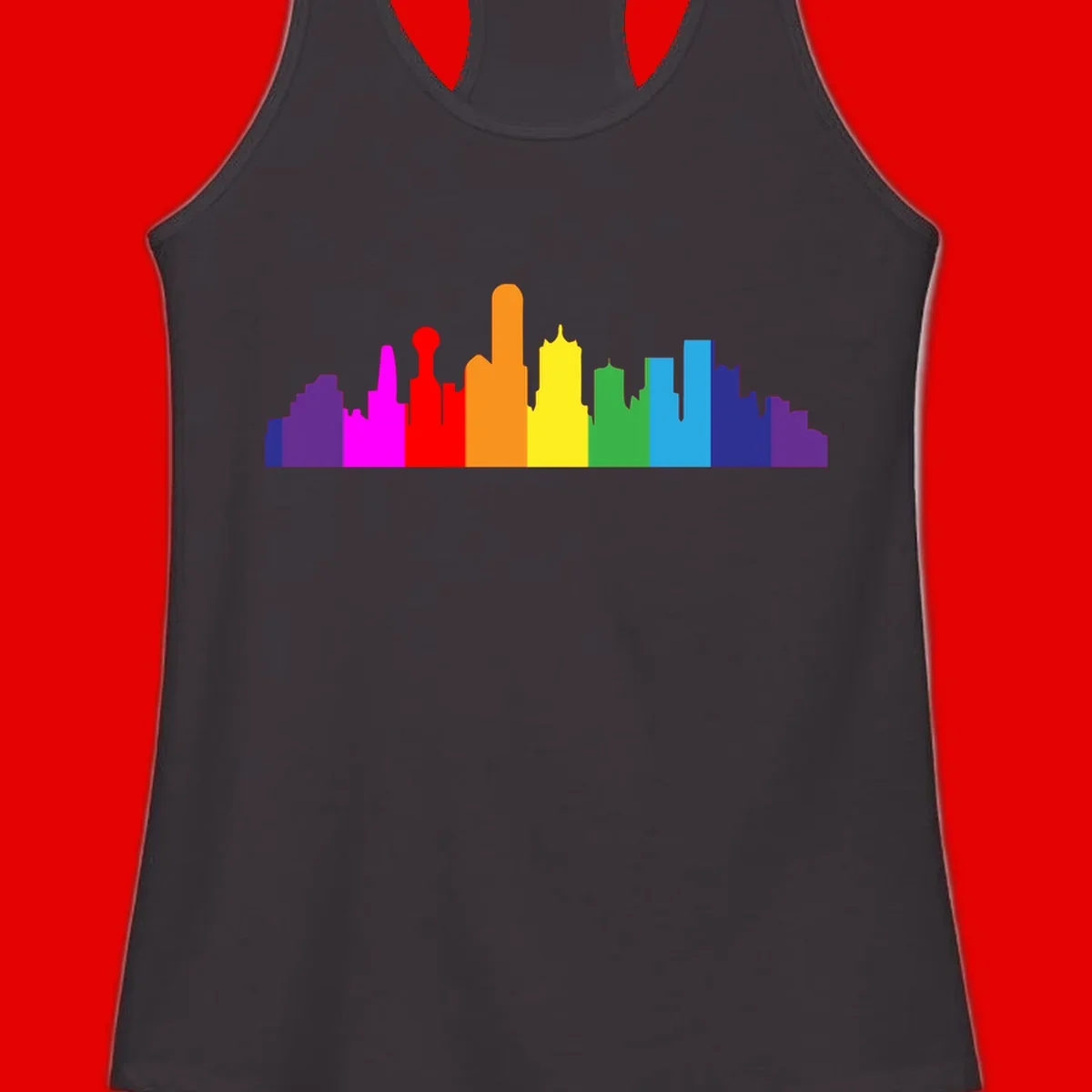 Colorful city skyline silhouette in rainbow pride colors transitioning from purple through red, orange, yellow, green, cyan and blue