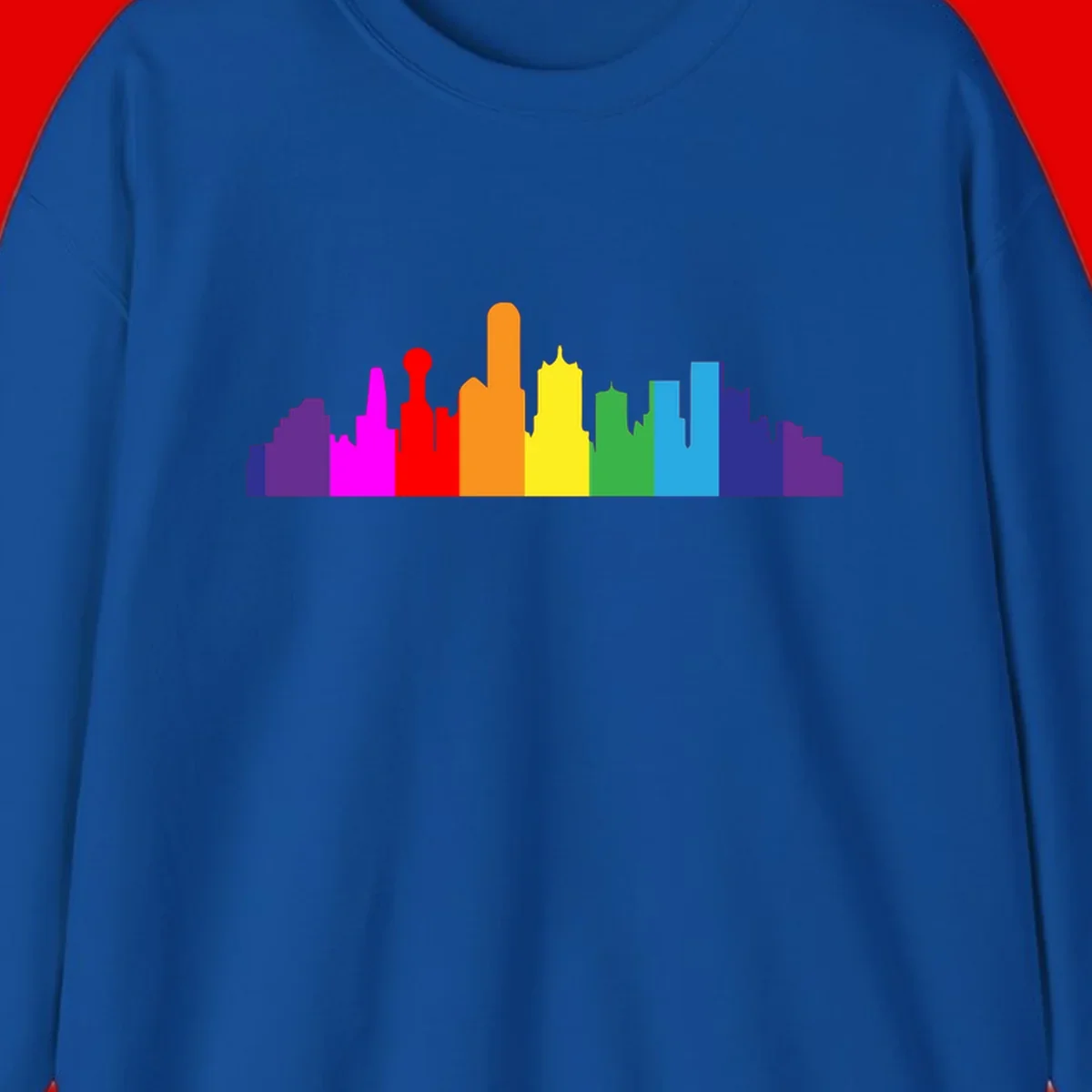 Colorful city skyline silhouette in rainbow pride colors transitioning from purple through red, orange, yellow, green, cyan and blue