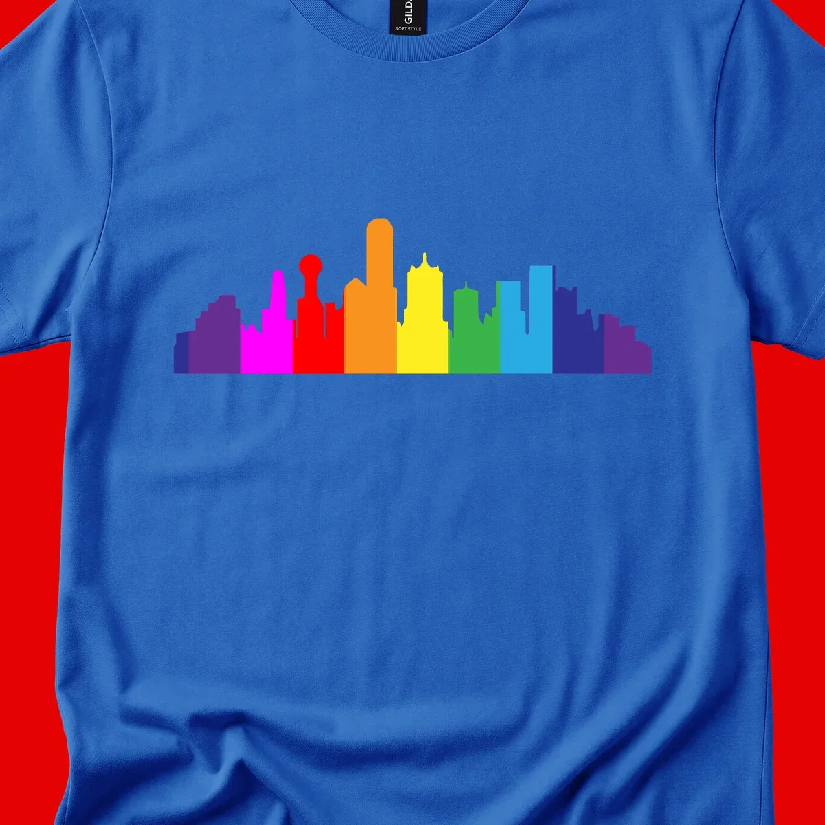 Colorful city skyline silhouette in rainbow pride colors transitioning from purple through red, orange, yellow, green, cyan and blue