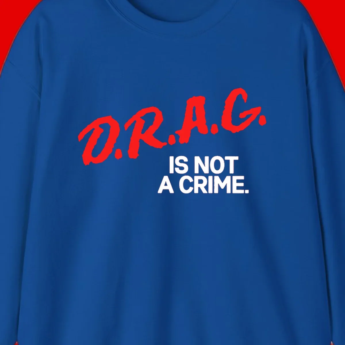 Bold red LGBTQ+ letters with white text reading 'IS NOT A CRIME' on gray background, pride statement design.