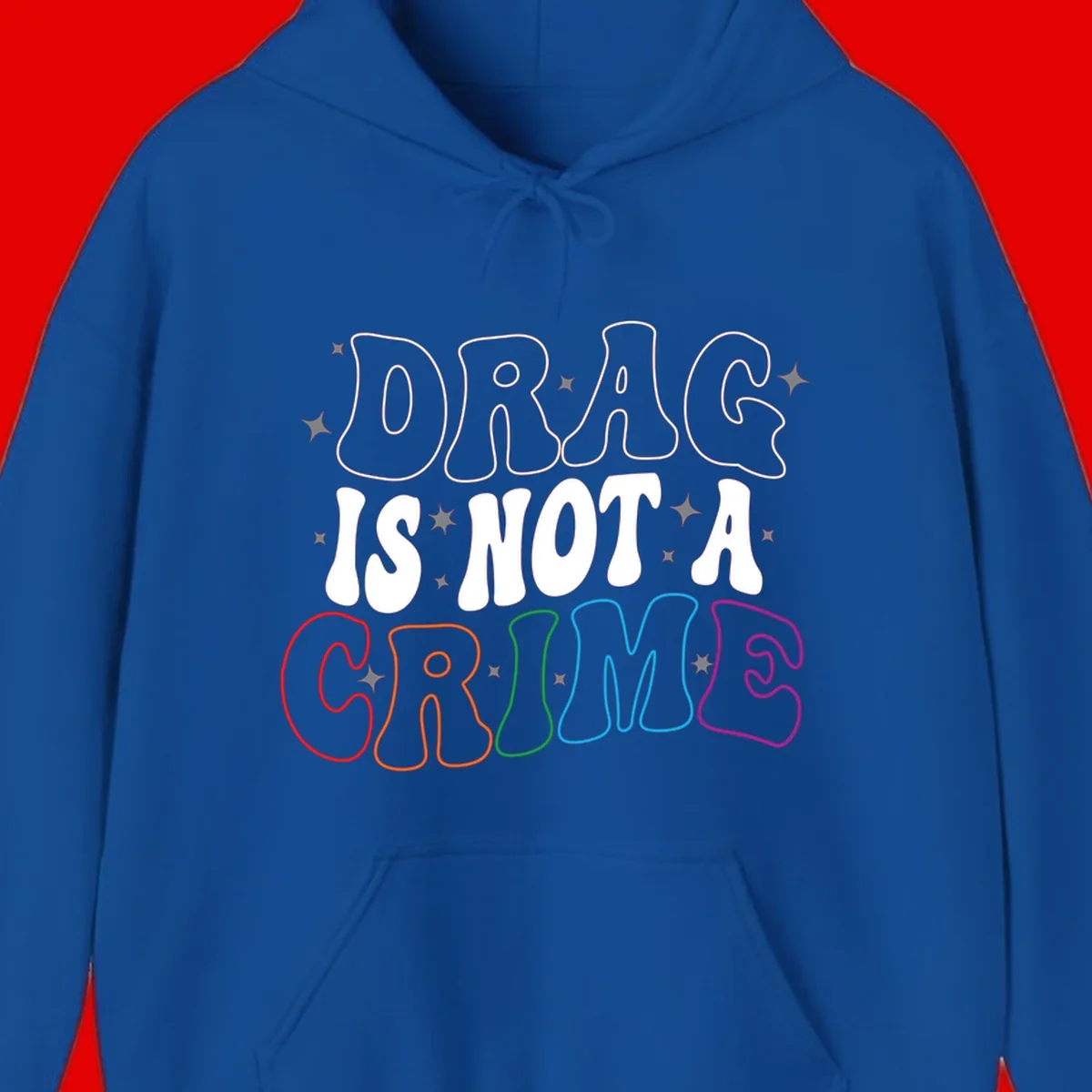 Drug is not a crime design with rainbow pride colored letters on gray background, promoting social justice and harm reduction advocacy