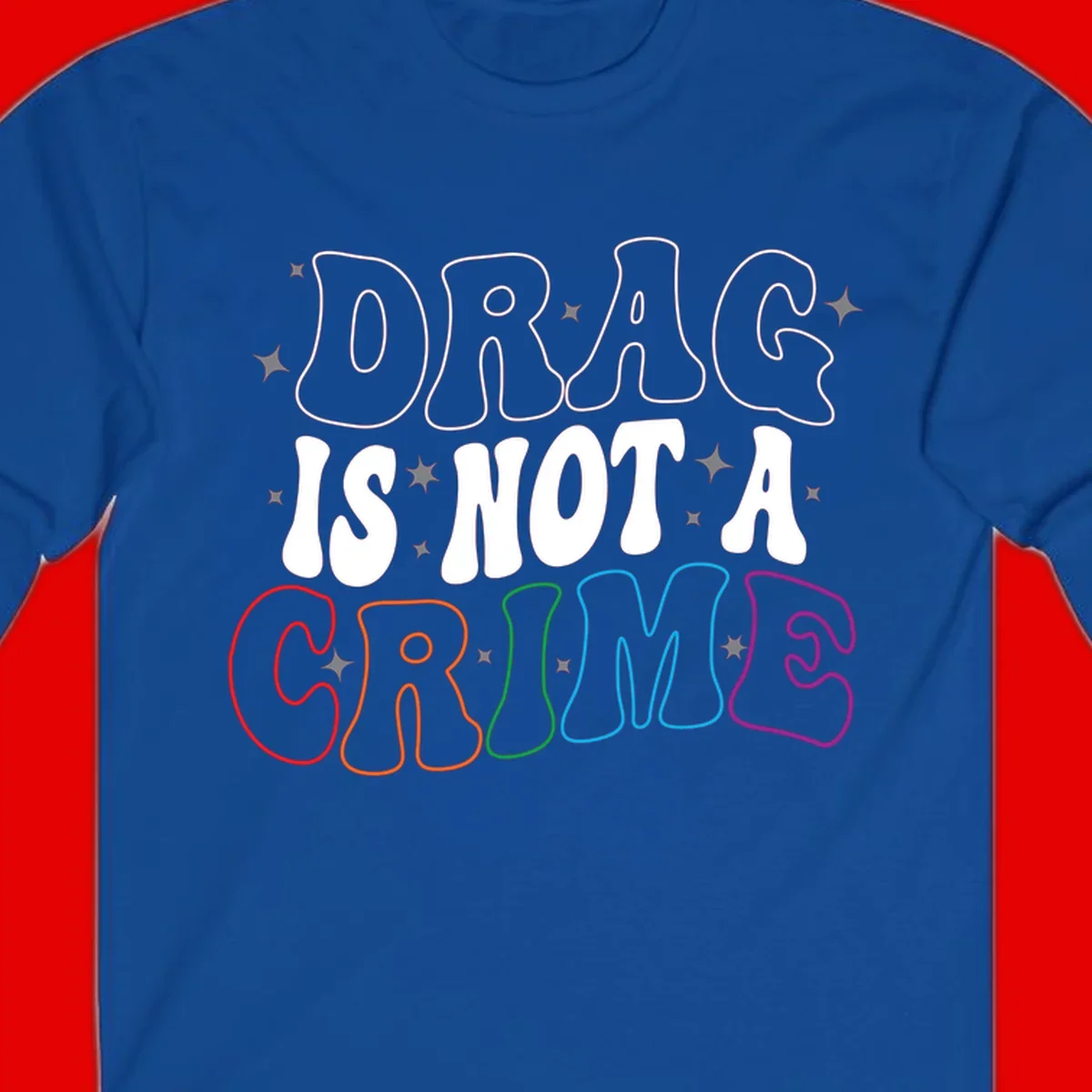 Drug is not a crime design with rainbow pride colored letters on gray background, promoting social justice and harm reduction advocacy