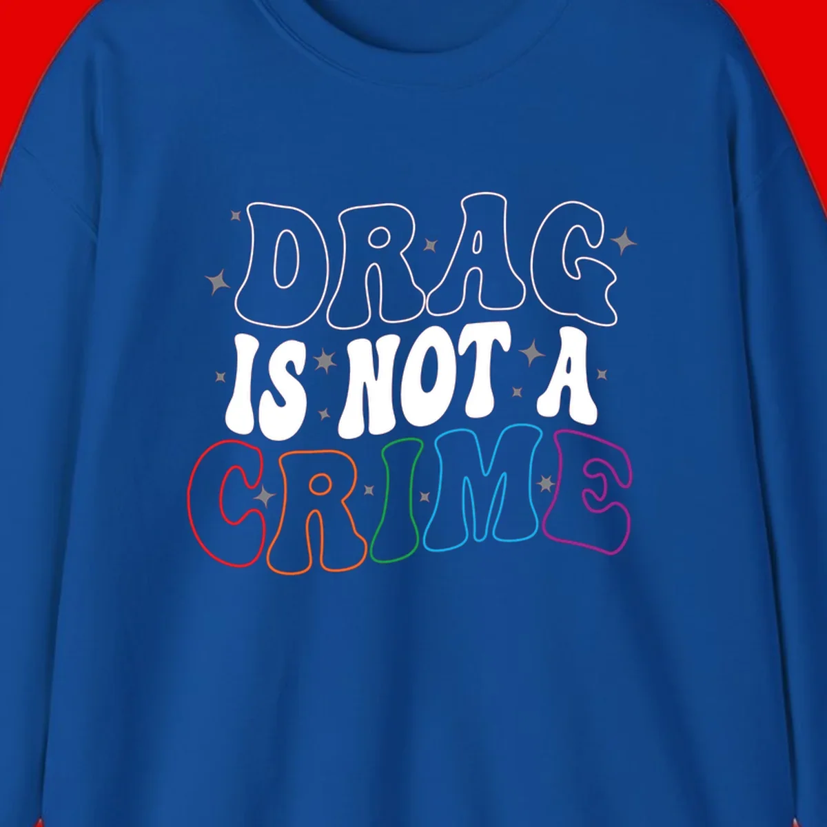 Drug is not a crime design with rainbow pride colored letters on gray background, promoting social justice and harm reduction advocacy