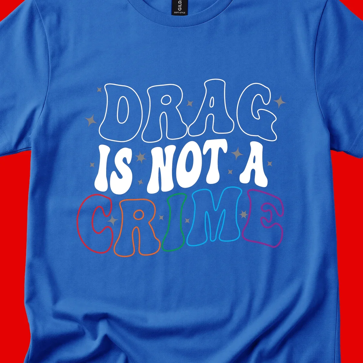 Drug is not a crime design with rainbow pride colored letters on gray background, promoting social justice and harm reduction advocacy
