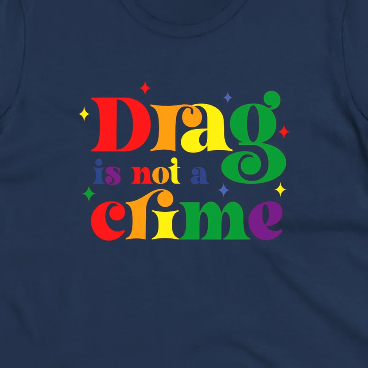Rainbow gradient text reading 'Drag is not a crime' with colorful stars on gray background