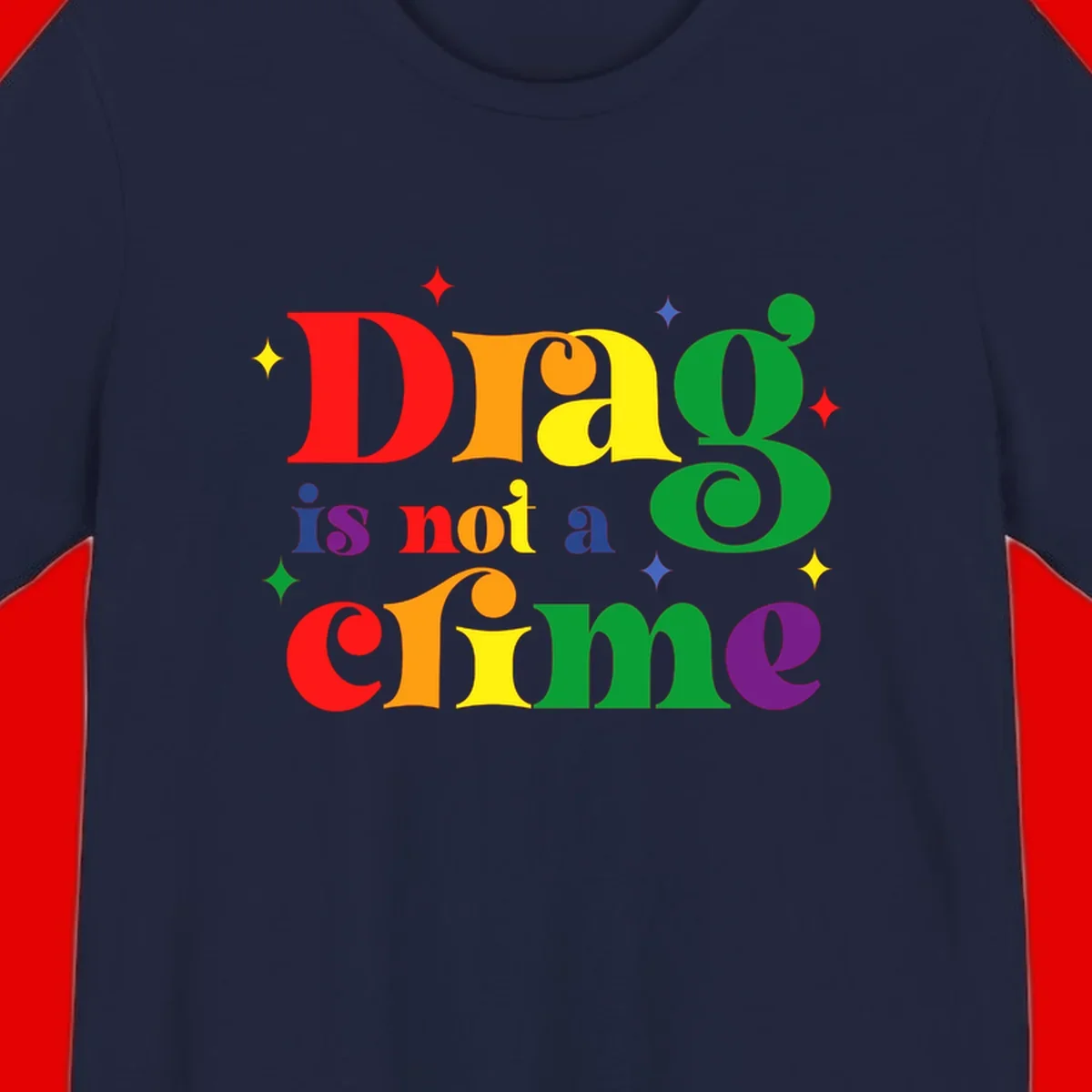 Rainbow gradient text reading 'Drag is not a crime' with colorful stars on gray background