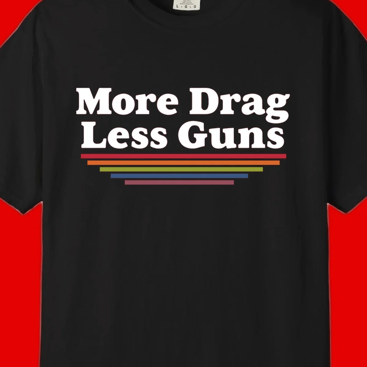 Bold white text reading 'More Drag Less Guns' with colorful horizontal bars below on gray background